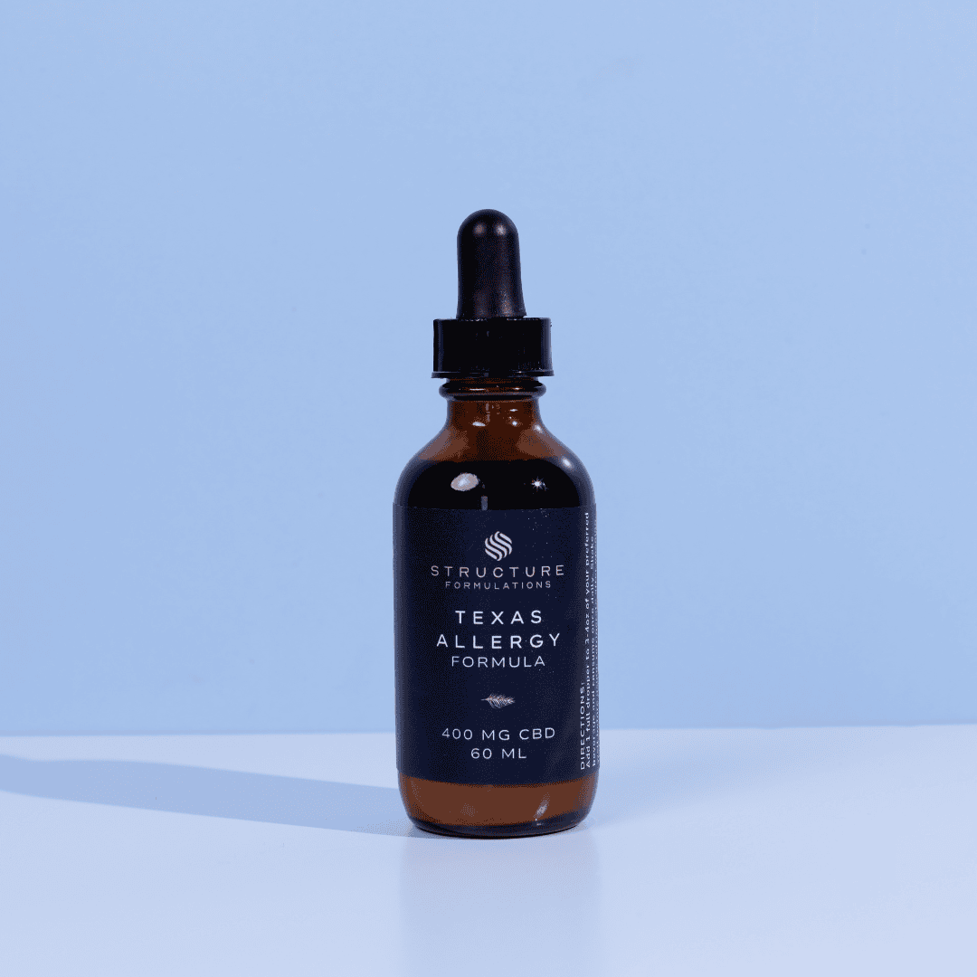 Cbd allergy relief formula dropper bottle with black label on light blue background.